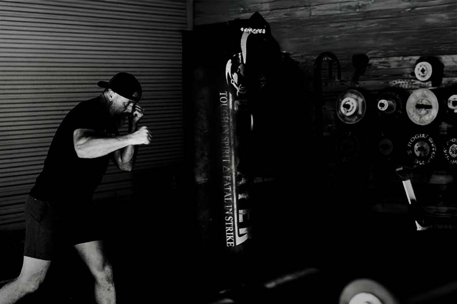 Keith Vance training on the heavy bag — black and white